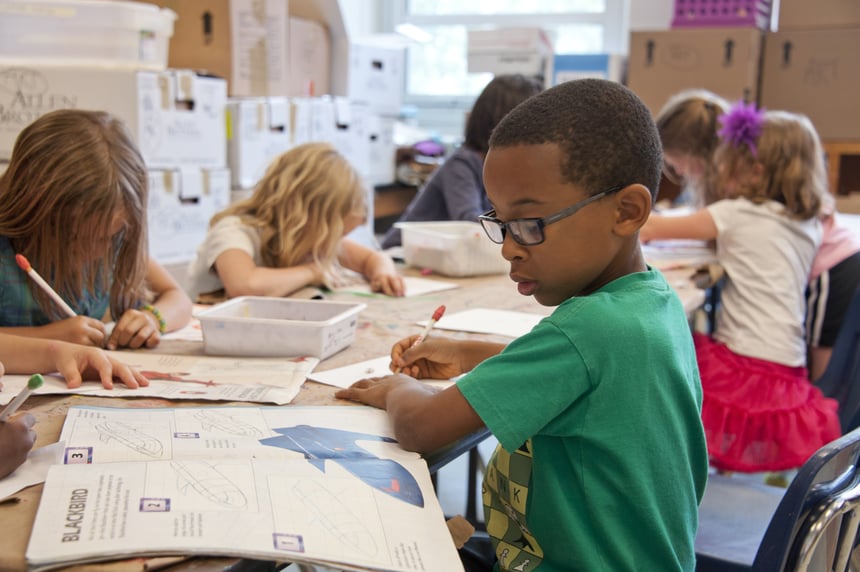 Children in a classroom working together on school assignments.